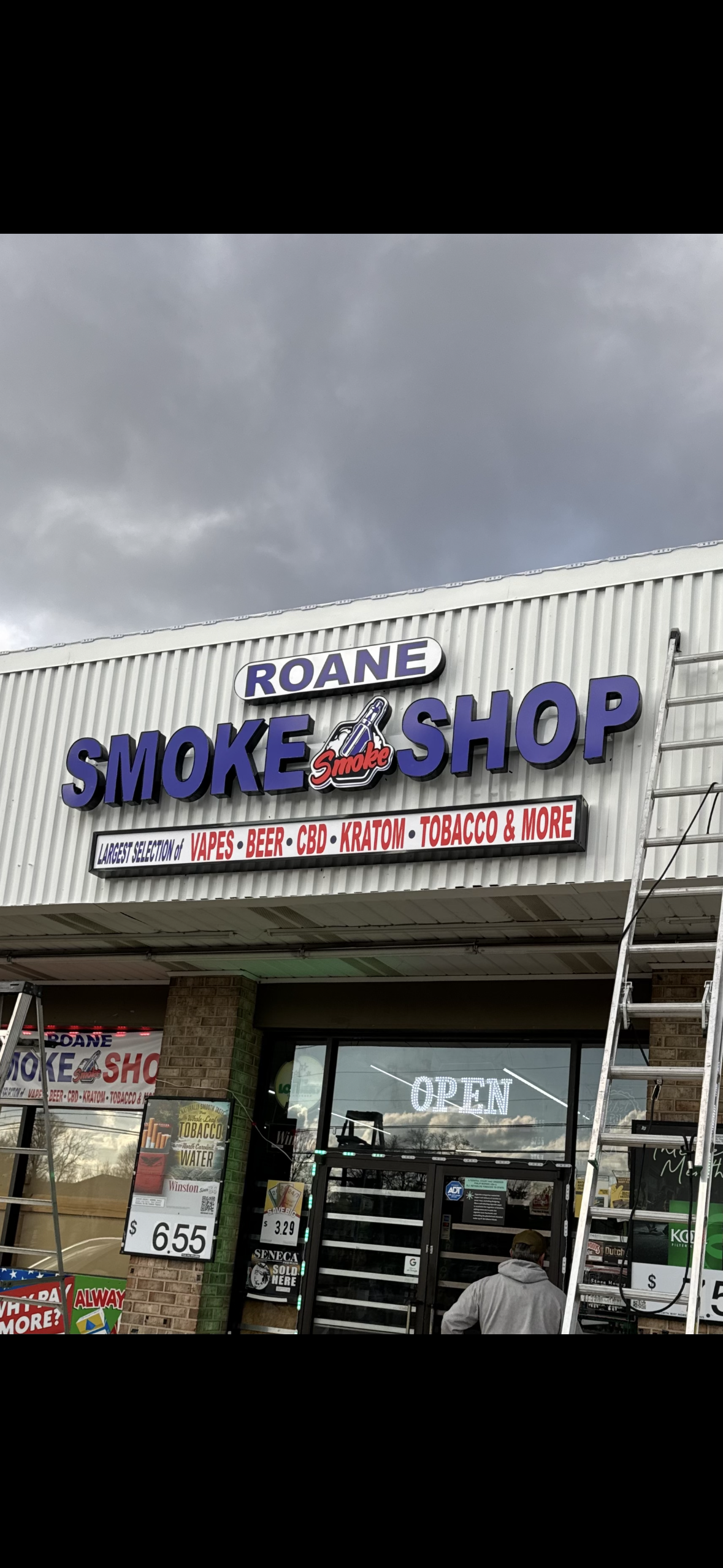 Roane Smoke Shop illuminated storefront sign